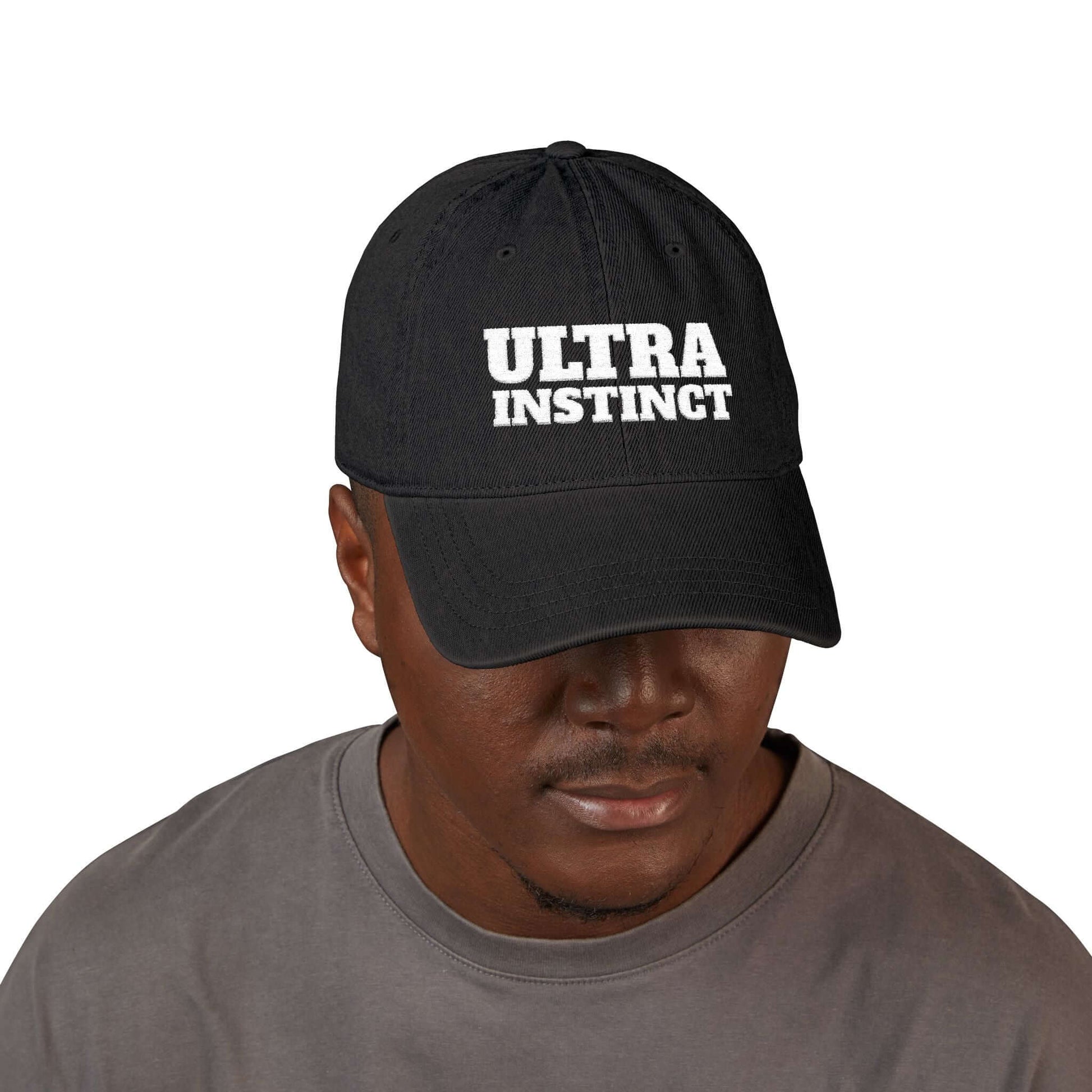 Black unstructured denim hat with 'Ultra Instinct' embroidery, worn by a man showcasing casual style.